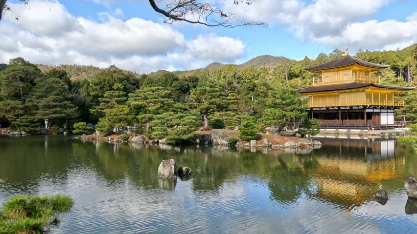 Kinkakuji temple on a pond, Kyoto, Japan. Video in autumn season on a sunny day.
