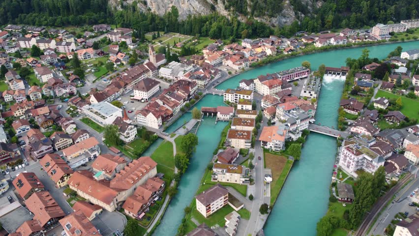 Interlaken, Switzerland: Aerial downward drone footage of the Interlaken old town with the Aar river, the market square (Marktbrunnen) and the Unterseen old church in Canton Bern