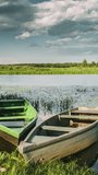 Lake Or River And Old Wooden Rowing Fishing Boats In Beautiful Summer Sunny Evening vertical, vertical footage, vertical video.
