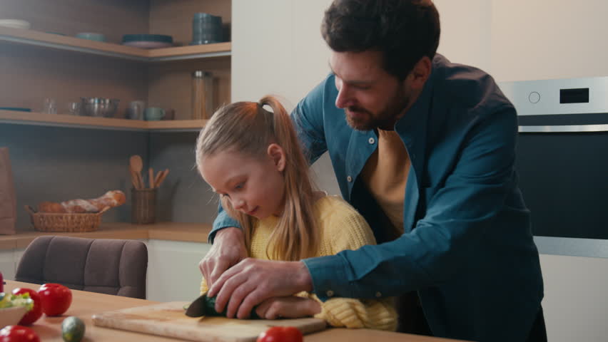Happy family at home medical insurance food delivery healthy nutrition health care father help teach little child kid girl daughter cut fresh cucumber vegetable kitchen prepare salad together cooking Royalty-Free Stock Footage #3484062749