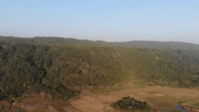 Aerial video drone shots of the beautiful green and lush landscape in Bangladesh, in the nothern area of Sylhet. The green park and nature in the hilly area is known for its tea gardens and rivers