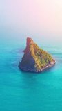 Aerial drone video of tropical paradise exotic island. Top down aerial of  island. Aerial vertical, vertical video background.