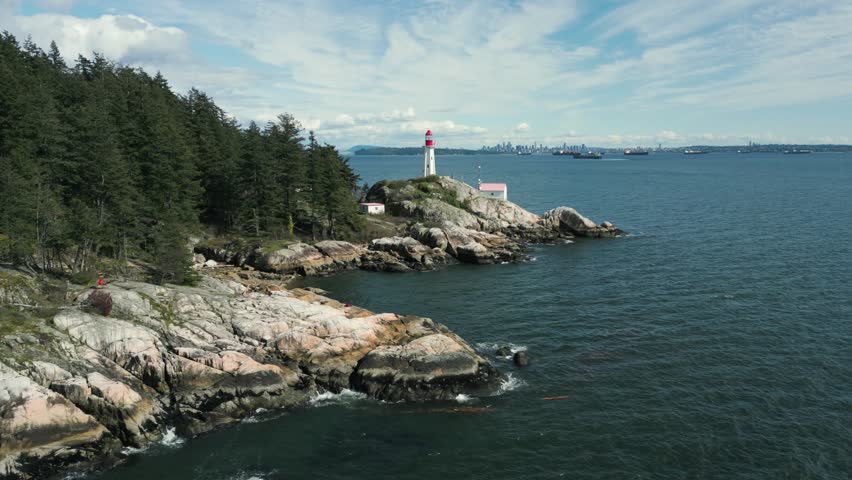 aerial shot toward point atkinson lighthouse in Lighthouse park in West Vancouver near Vancouver city in british columbia in Canada