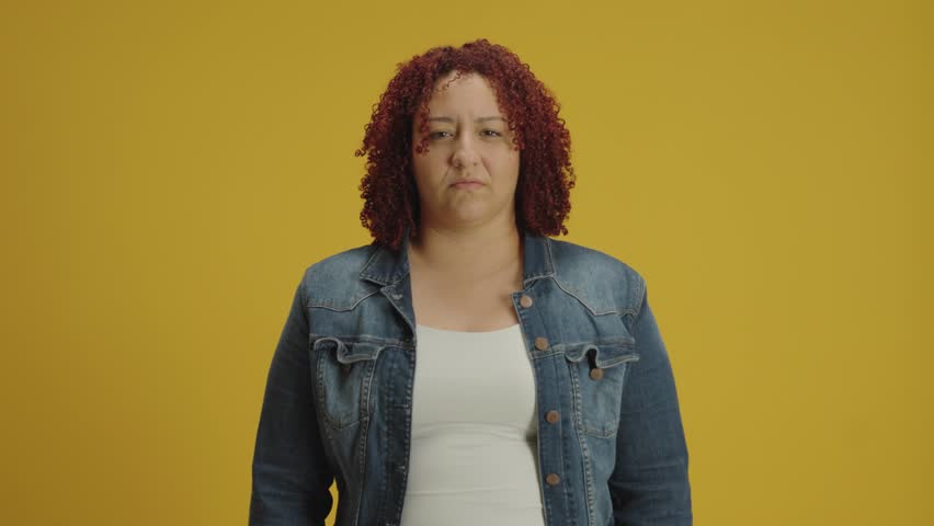Are you crazy, out of mind. Confused woman pointing at camera and showing stupid gesture, blaming asking some idiot for insane plan, knock head, bullying isolated on yellow background look angry.
 Royalty-Free Stock Footage #3484179391