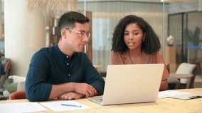 Two busy business people man and woman working on computer discussing online project at work. Diverse professional workers team talking on financial technology or marketing data using laptop in office - Powered by Shutterstock - Get 15% off with code: PIKWIZARD15