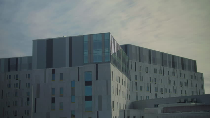 timelapse of exterior Finland hospital with clouds passing through