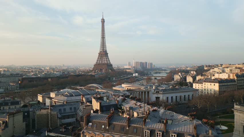 Tour Eiffel tower and Seine River, Paris in France. Aerial drone ascending