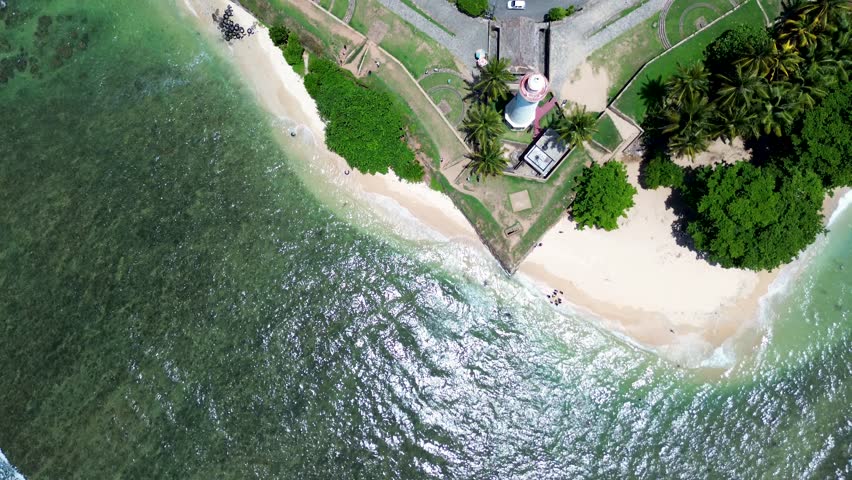 Aerial drone landscape of Galle lighthouse and apartment, hotel and shops rooftops in street historic Dutch old town square Sri Lanka travel tourism Asia