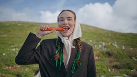 Smiling woman eating carrot on green farm field. Closeup funny girl biting healthy snack chewing crunchy vegetable. Carefree happy vegetarian looking camera outdoors. Organic food dieting concept. - Powered by Shutterstock - Get 15% off with code: PIKWIZARD15