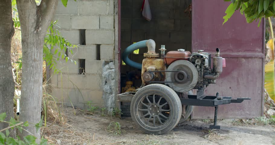 Portable water pump.A large water pump uses an engine to pump water up from the basement.
