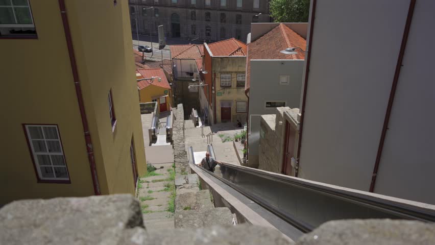 Moving staircase Monte dos Judeus ascends to top of hill in Porto, Portugal. Escadas Monte dos Judeus mechanised pedestrian walkways connect Palacio de Cristal hill through Miragaia to Virtudes hill. 