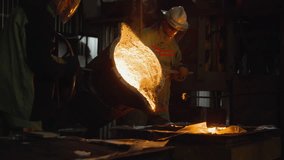 Industrial foundry workers pouring molten metal from a large ladle - Powered by Shutterstock - Get 15% off with code: PIKWIZARD15