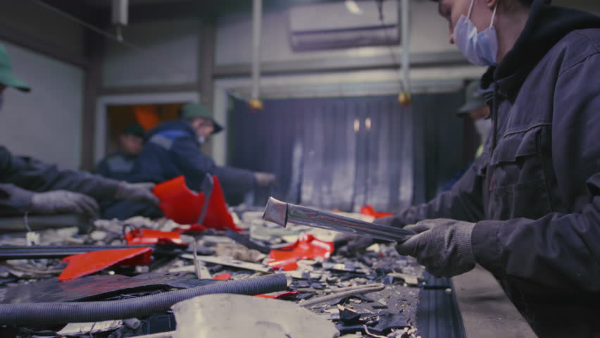 Professional team assesses each piece of garbage for recycling purpose at factory slow motion. Workers feel sense of accomplishment knowing about contribution to cleaner and  more sustainable future