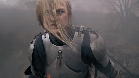 The furious Jeanne d Arc screams standing in the smoke, slow motion