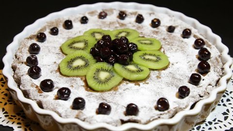 Marasca cherry choco pie decorated with fresh kiwis - selective focus on middle of the pie 库存视频