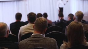Audience at the modern conference hall listens to panel discussion, people on a congress together listen to speaker on stage at convention, business seminar, amphitheater venue for presentation - Powered by Shutterstock - Get 15% off with code: PIKWIZARD15