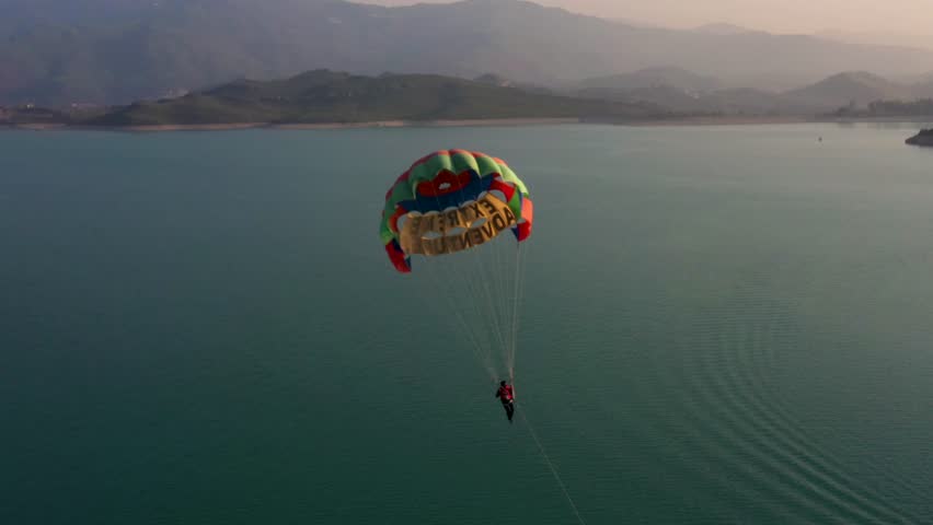 Man Flying on Parachute Wide Aerial Top View