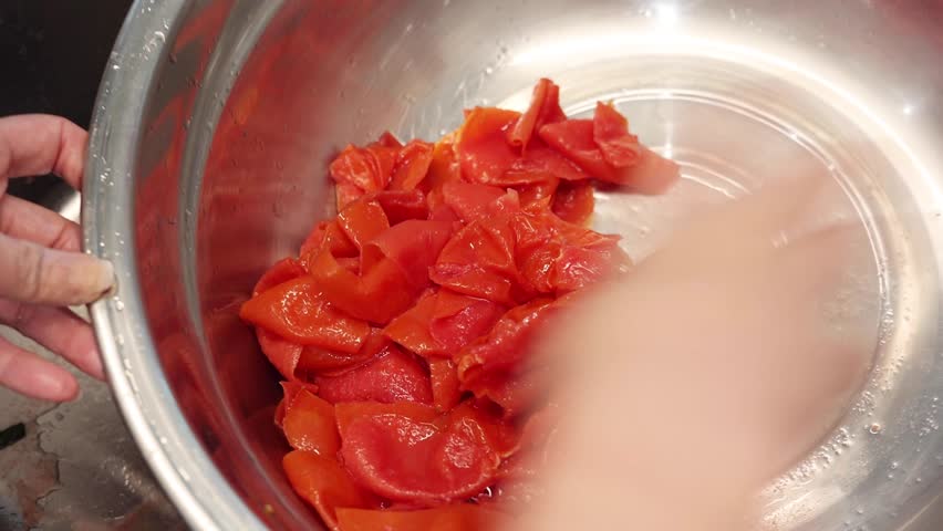 Boiled tomato skins, peeling tomato skins, incorporating tomato skins Royalty-Free Stock Footage #3484762365