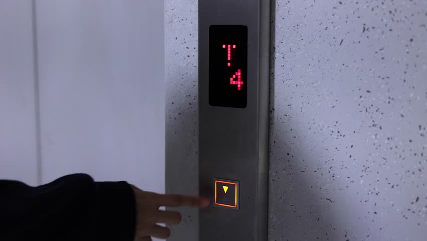 A hand repeatedly pressing elevator buttons, playing with buttons, impatiently irritated while waiting for the elevator