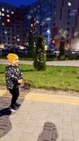 Happy kid park having fun. Small boy playing outdoor in the evening. Vertical video.