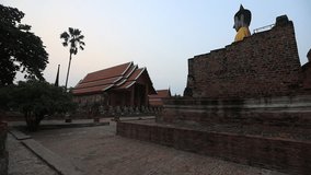 Natural video background of a religious tourist attraction in Ayutthaya, Thailand. Wat Yai Chai Mongkhon has ancient trees and Buddha statues that are worthy of preservation and study of their history