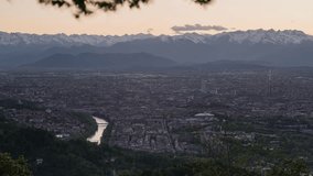 Turin, Italy. Panoramic view over the city from Superga hill. On the left the Po river and Murazzi. Mole Antonelliana dome in the centre. Day to Night 4K Timelapse video.