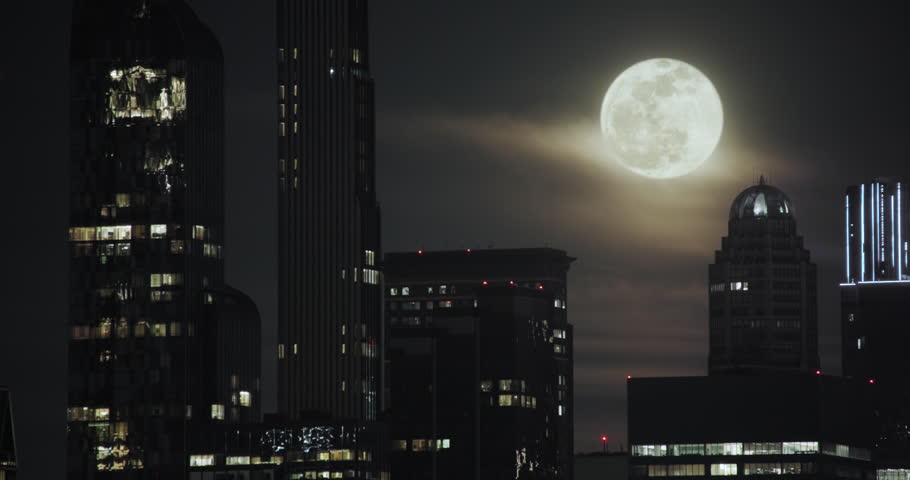 New York City Skyline with Full Moon Rising Over Buildings