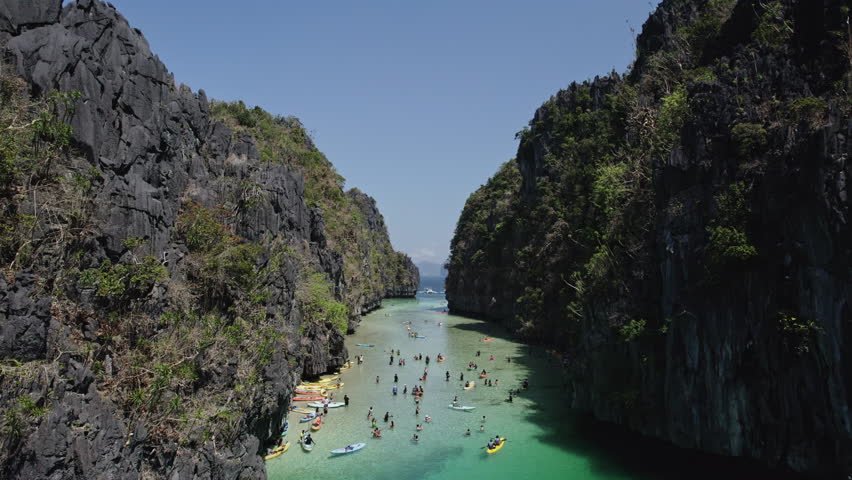 POV drone inder in a big lagoon under canoes in palawan, fpv flight
