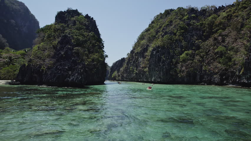 POV in a big lagoon under canoes in palawan, fpv flight
