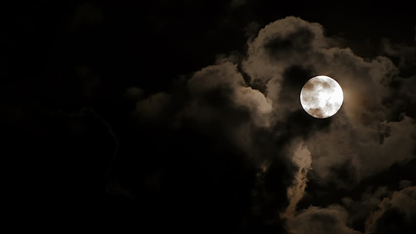 Person exhales smoke in the darkness, creating a cloudlike effect