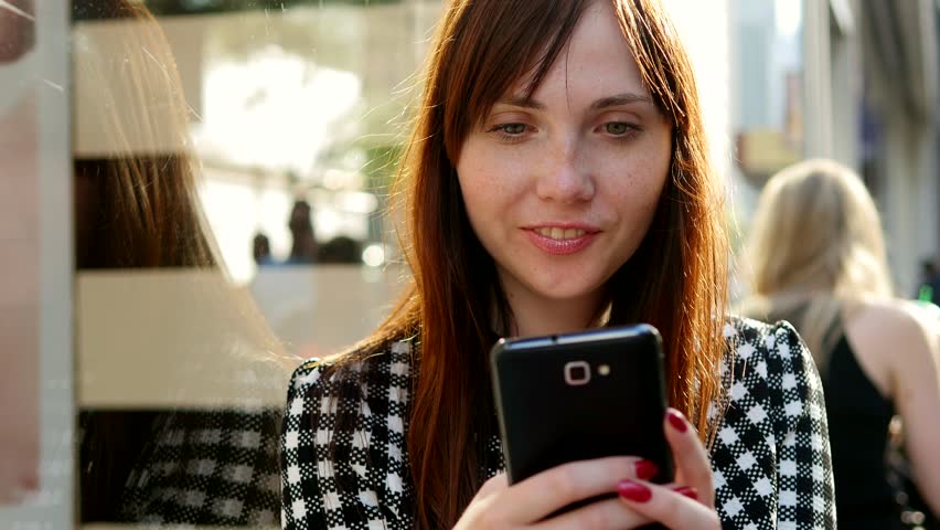 A Woman Stays Connected with her Smart Phone