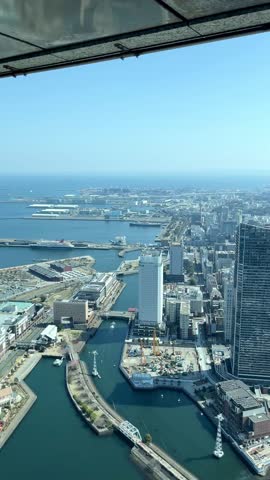 Yokohama, vertical video of a top view of Yokohama in Japan. Aerial city landscape with landmarks and bustling streets at daytime in Yokohama a city in Japan.