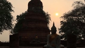 Nature video background of a religious tourist attraction in Ayutthaya, Thailand. Wat Phra Ngam(Portal of Time)has ancient trees and Buddha statues that are worth preserving and studying their history