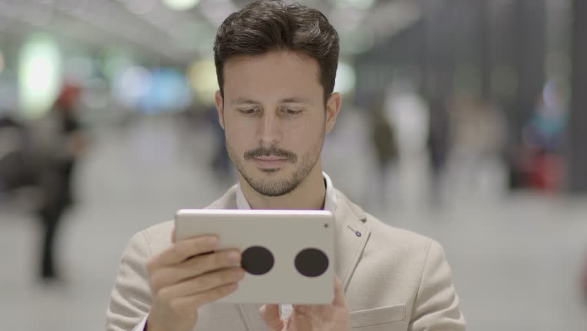 Man Immersed in the Digital World with his Fingers Across the Touchscreen