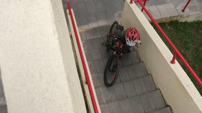 boy is trying to carry his bicycle up the steps. boy overcomes an obstacle  - Powered by Shutterstock - Get 15% off with code: PIKWIZARD15