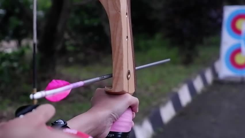 a video footage of shooting an arrow to a target in slow motion
