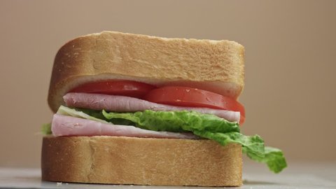 closeup of man's hand press the sandwich. finish movement to sandwich preparation