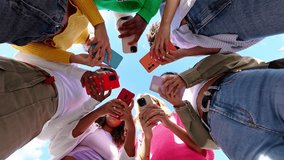 Young group of student women using smartphone together outside. Addicted millennial female friends using cell phone at city street. Low angle view. - Powered by Shutterstock - Get 15% off with code: PIKWIZARD15