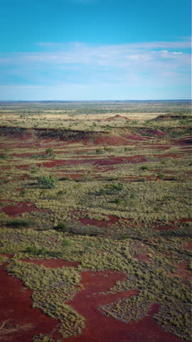 Desert Escarpment in Western Australia, Drone shot pulling down over read earth, wide countryside and hills, beautiful desert background