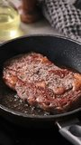 A chef cooks a beef steak on a pan in the kitchen and turns it to the other side, close-up. Process of making delicious steak.