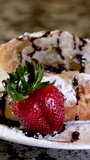 closeup of croissant sprinkled with powdered sugar with strawberries and mint leaves delicious dessert french breakfast restaurant serving cook at home decorate many different videos with strawberries