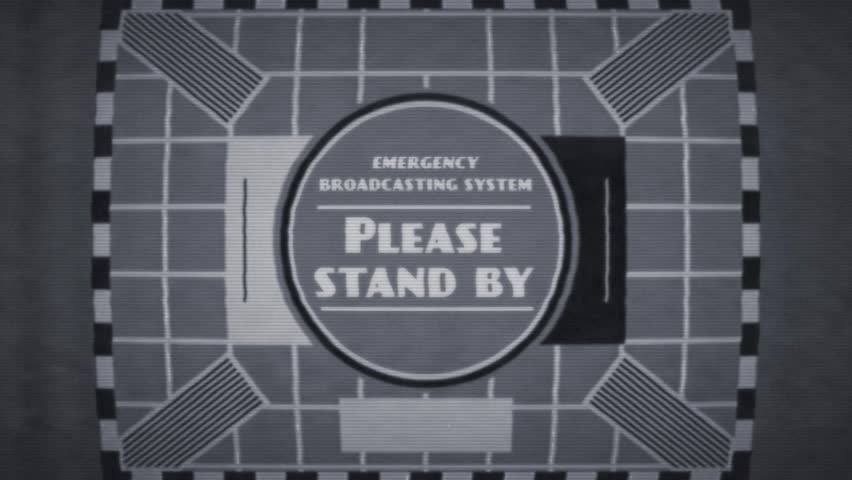 A TV caption card in a retro 1950s style with the wording ‘Emergency Broadcasting System, Please Stand By’. The graphics are stylised in a poor-quality black and white analogue TV style, with a vintag