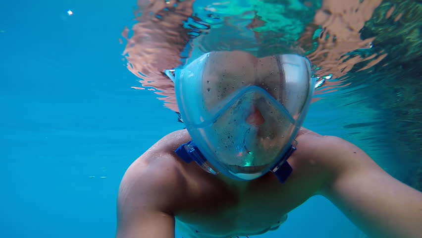 Handsome man snorkeling with new mask over the entire face. Slow motion man snorkeling. Exploring deep sea. Cinematic look. | Shutterstock HD Video #34855447