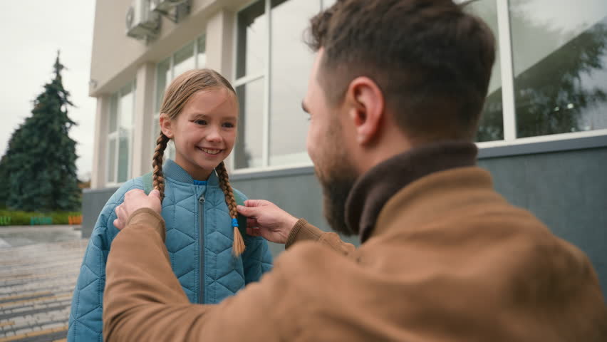 Father and daughter primary school farewell touch nose cute family joy happiness parenthood man girl schoolgirl study lessons gesture outside city kid child education pupil relations bond protecting Royalty-Free Stock Footage #3485589567