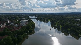 An aerial drone view of Aasee Lake in Münster . Lake Aasee is an artificial lake located in Münster , Germany .
