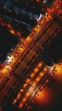 illuminated streets of Spanish touristic city Salou, Catalonia, aerial view of main street with alley of palm trees and lights, directly above vertical video 4k