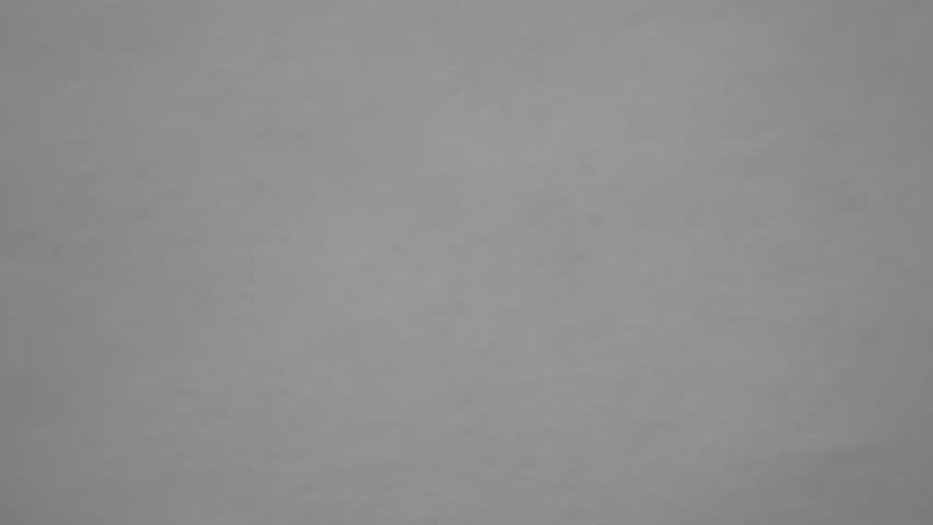 Yellow pills are scattered on a white surface.