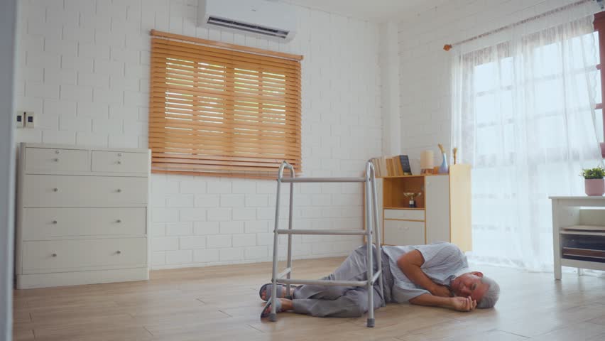 Asian senior elderly male fall on the ground while walk alone in house. Mature older grandfather having an accident and fainting while doing physical therapy after retirement in living room at home. - Powered by Shutterstock - Get 15% off with code: PIKWIZARD15