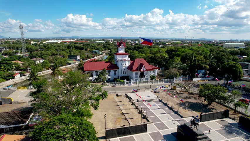 Kawit, Cavite, Philippines - Mar 28, 2024: Aerial flyby of Emilio Aguinaldo Shrine and the Philippine Flag.