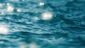 Close-up view of flickering ocean waves in slow motion, seamless loop background. Sunlights breathtaking beauty play on a wind wavy ocean surface. 3d render - Powered by Shutterstock - Get 15% off with code: PIKWIZARD15